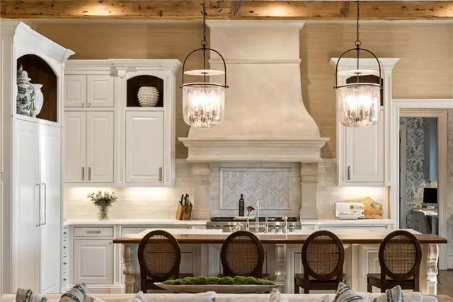 a view of a swimming pool with lawn chairs and iron fence