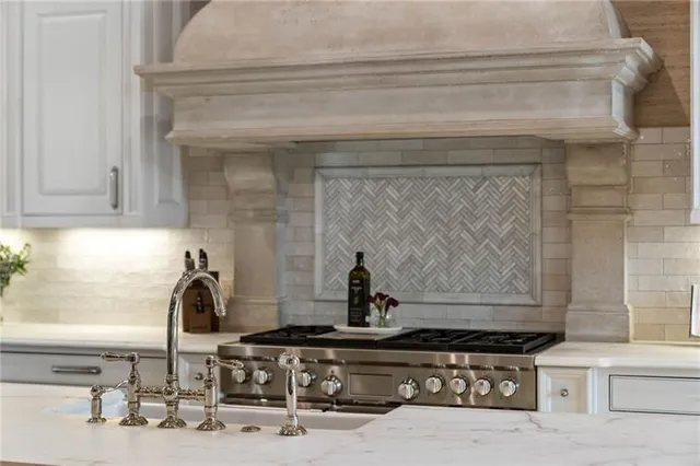 a view of a patio with table and chairs potted plants and a floor to ceiling window