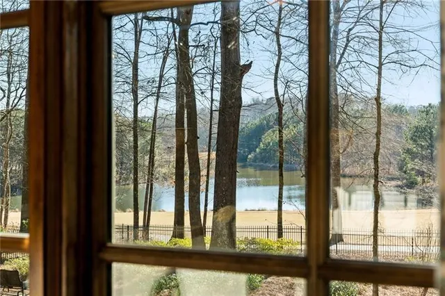 a living room with furniture a flat screen tv and a chandelier