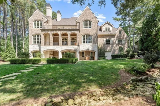 a living room with fireplace furniture and floor to ceiling window