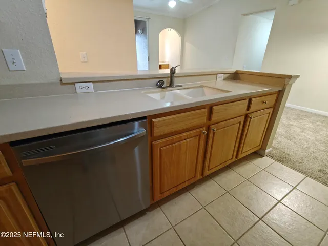 a view of a room with a ceiling fan and a window