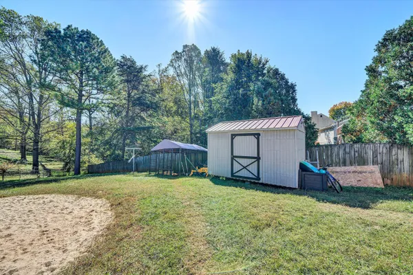 a view of a house with a yard and sitting area