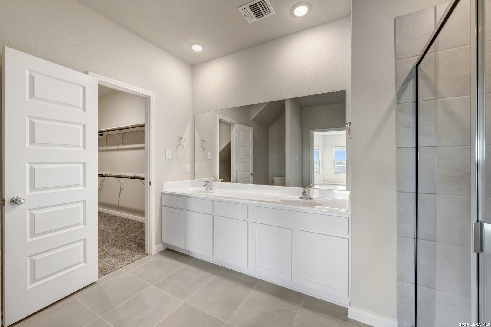 10330 Goodison Drive Converse, TX 78109 - Photo 21 of 42 a spacious bathroom with a double vanity sink and a mirror