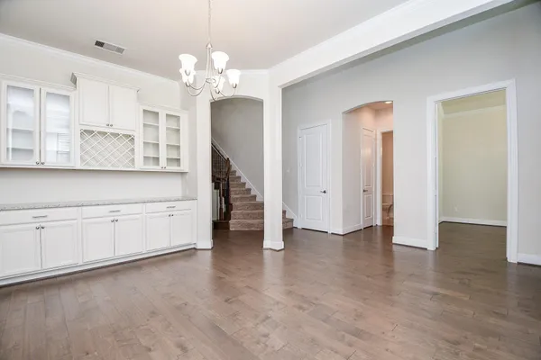 a view of a kitchen with granite countertop a white stove top oven and cabinets