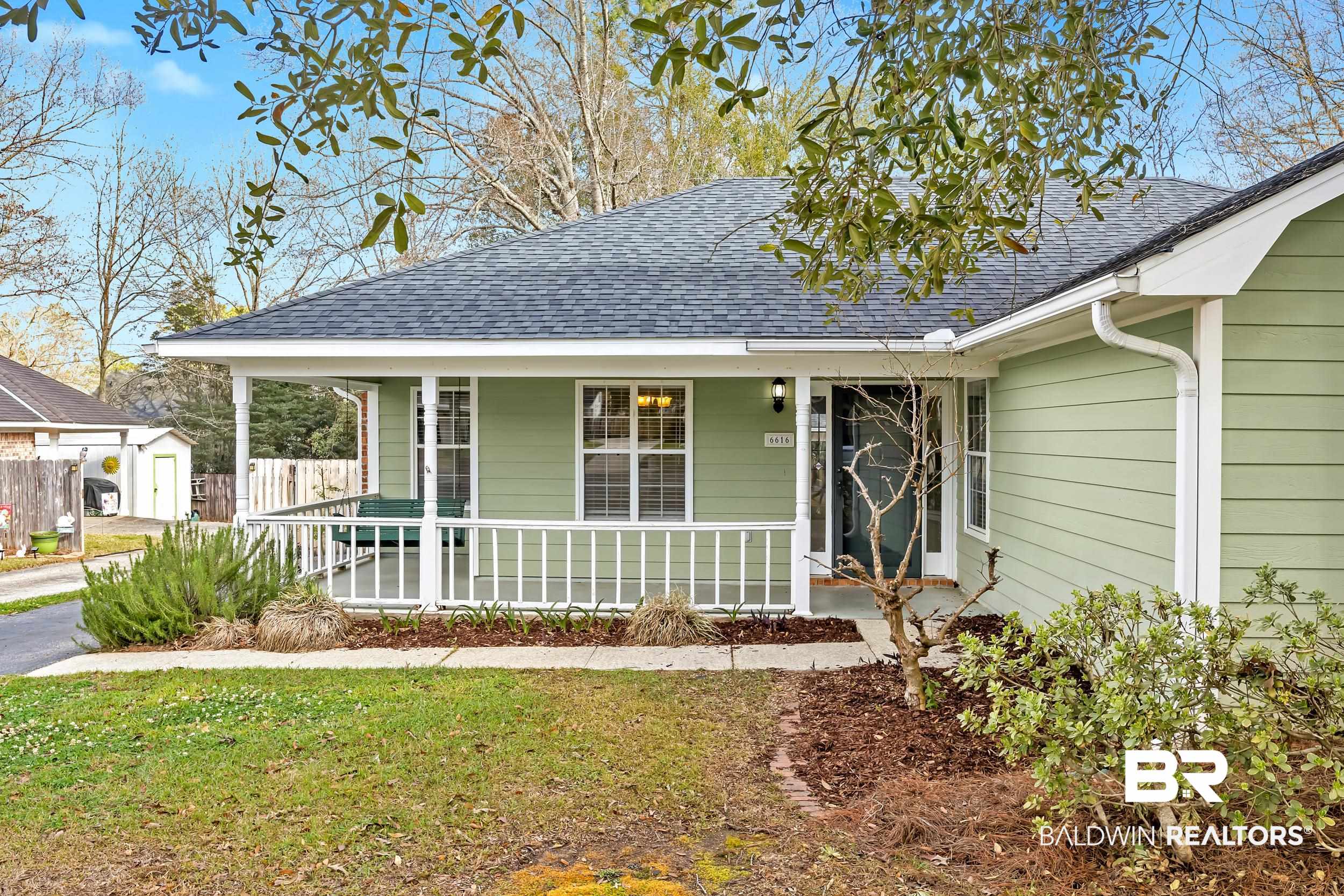 6616 Conde Court Mobile, AL 36695 - Photo 4 of 27 View of front of property with fence, covered porch, a front lawn, and a shingled roof