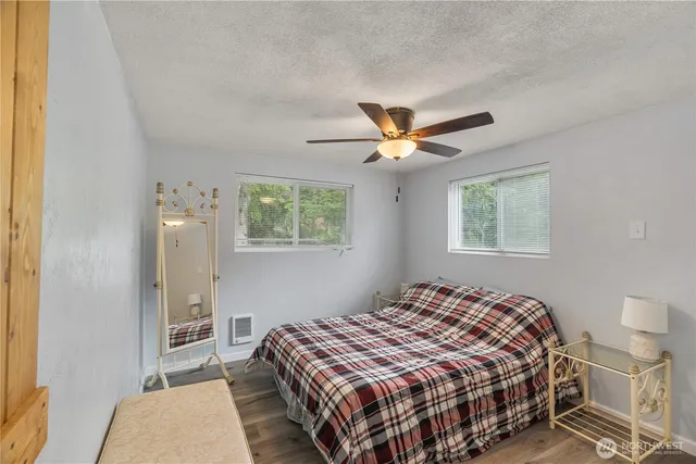 a bedroom with a bed and a lamp with window