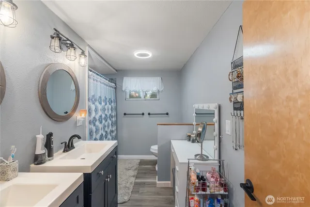 a bathroom with a sink a toilet and a mirror