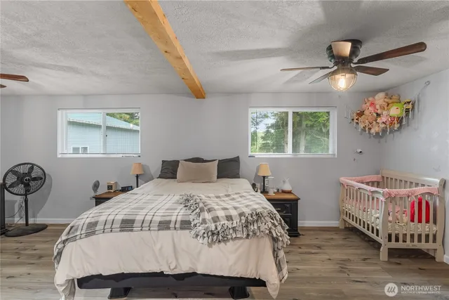 a bedroom with a bed and a chandelier