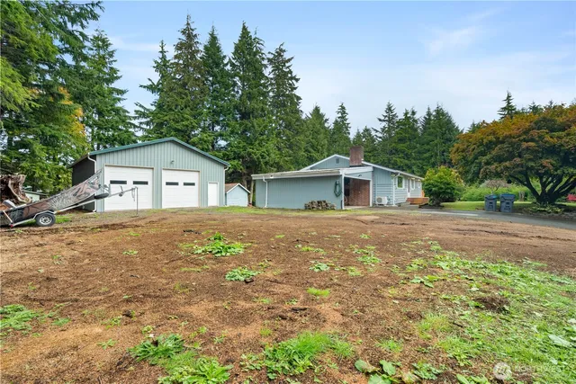 a front view of a house with a yard and trees