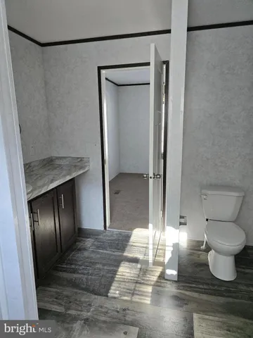 a bathroom with a granite countertop shower and a toilet