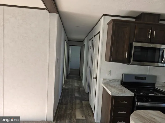 a kitchen with stainless steel appliances a refrigerator and a microwave