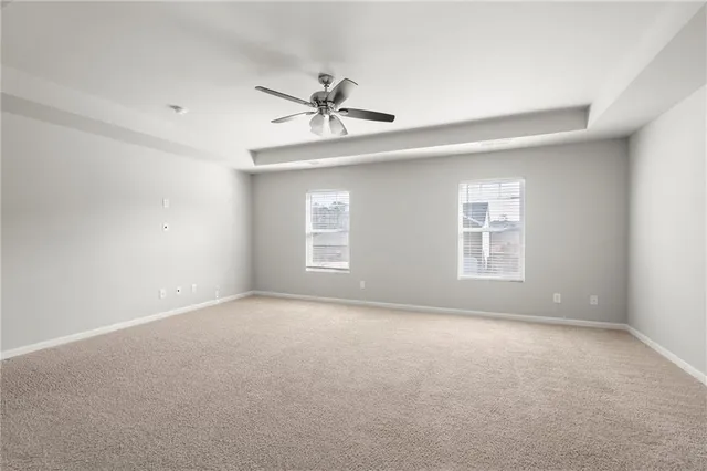 a view of a grey house with a yard