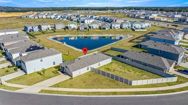 an aerial view of a house with a swimming pool