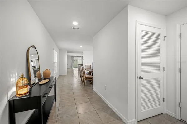 a view of a hallway to a livingroom with furniture