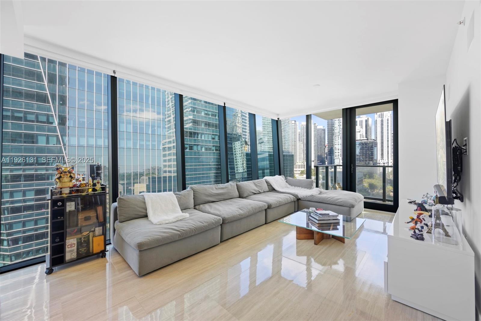 a living room with furniture and large windows