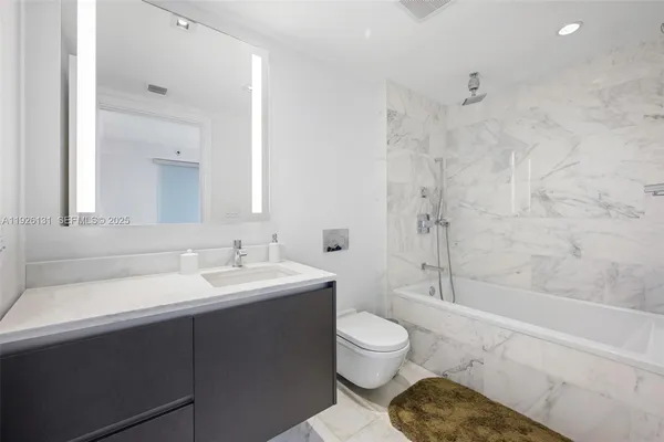 a bathroom with a sink toilet vanity and shower