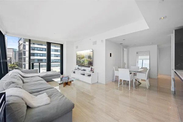 a living room with furniture and a large window