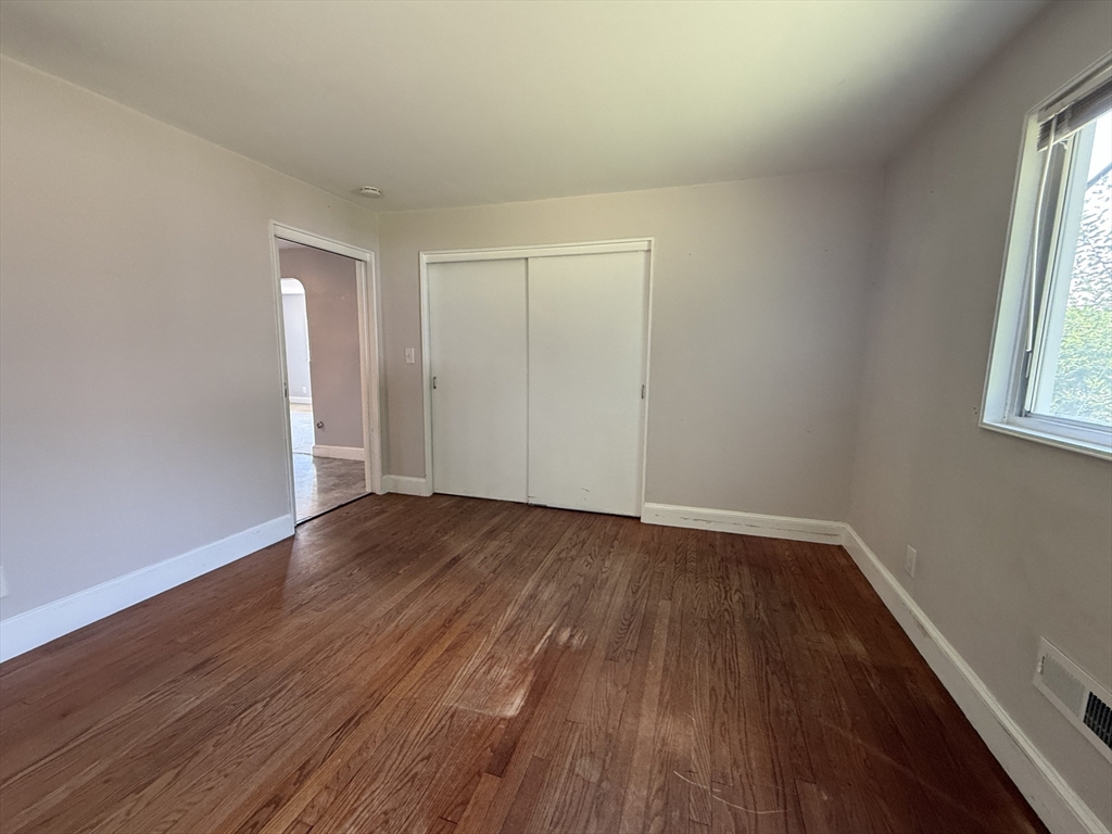 36 5th Avenue Lowell, MA 01854 - Photo 10 of 16 an empty room with wooden floor and windows