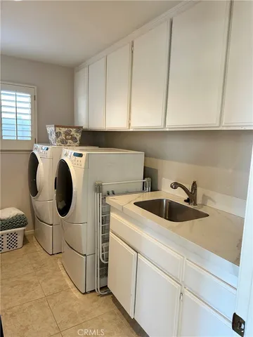 a kitchen with a sink and a stove next to a window