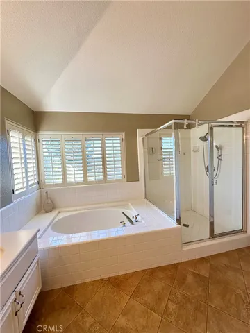 a spacious bathroom with a tub shower and sink
