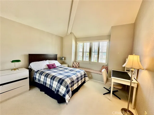 a bedroom with a bed chair and a window