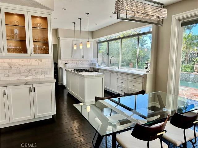 a kitchen with a stove a sink and cabinets