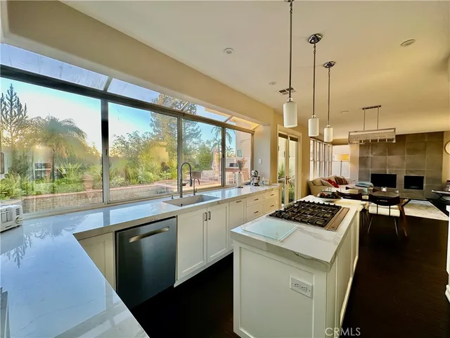 a kitchen with a stove a sink and cabinets