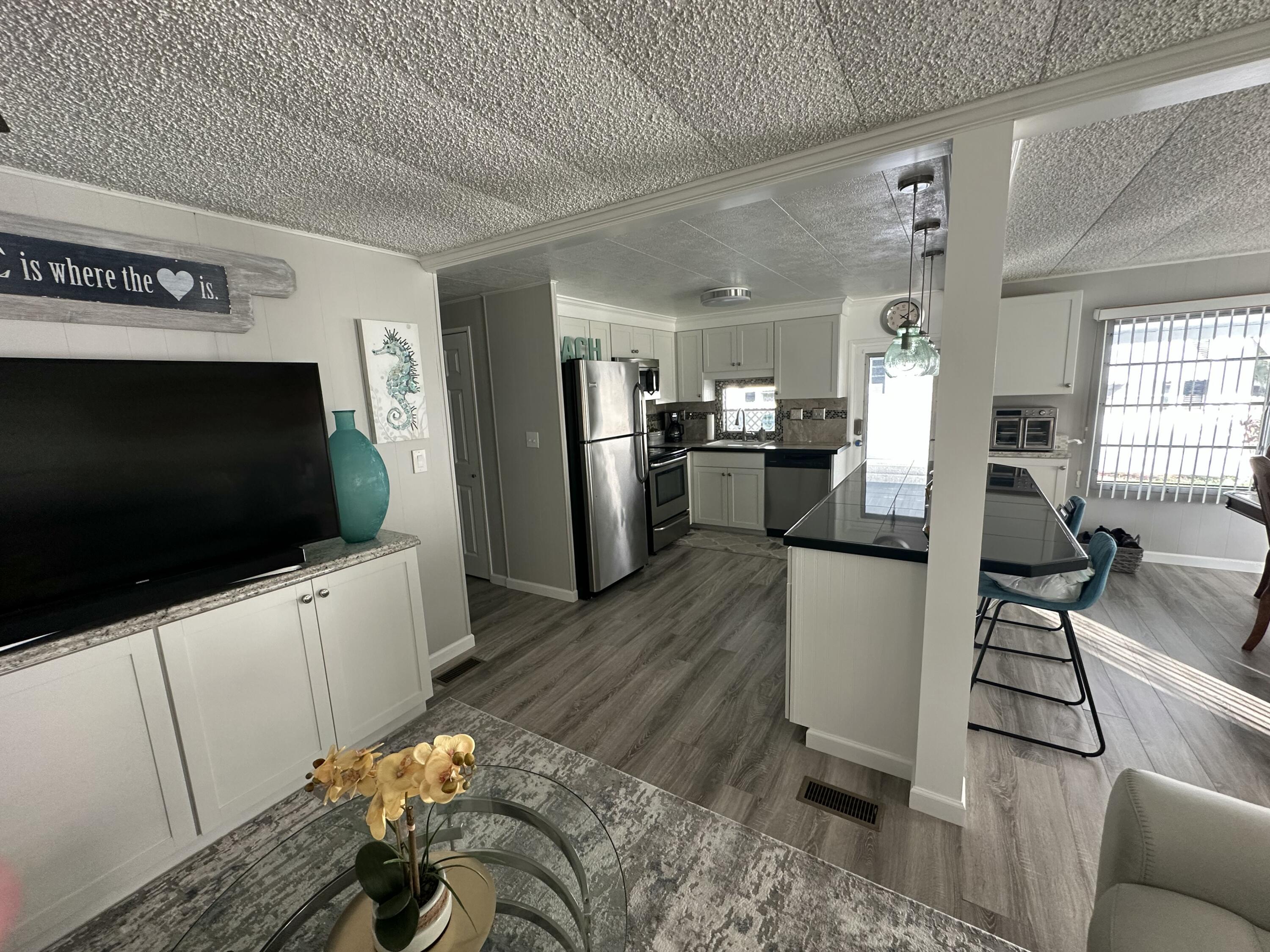 8281 South Street Boca Raton, FL 33433 - Photo 12 of 33 a living room with furniture and a flat screen tv