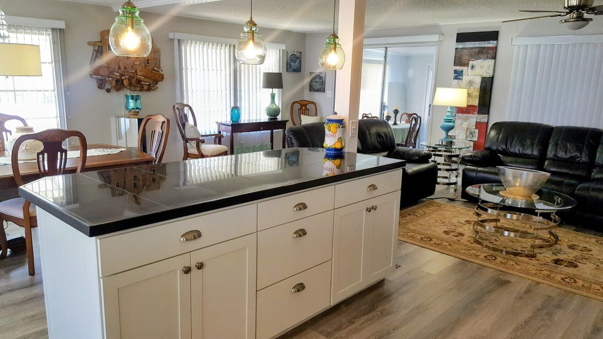 8281 South Street Boca Raton, FL 33433 - Photo 13 of 33 a kitchen with sink a stove and cabinets