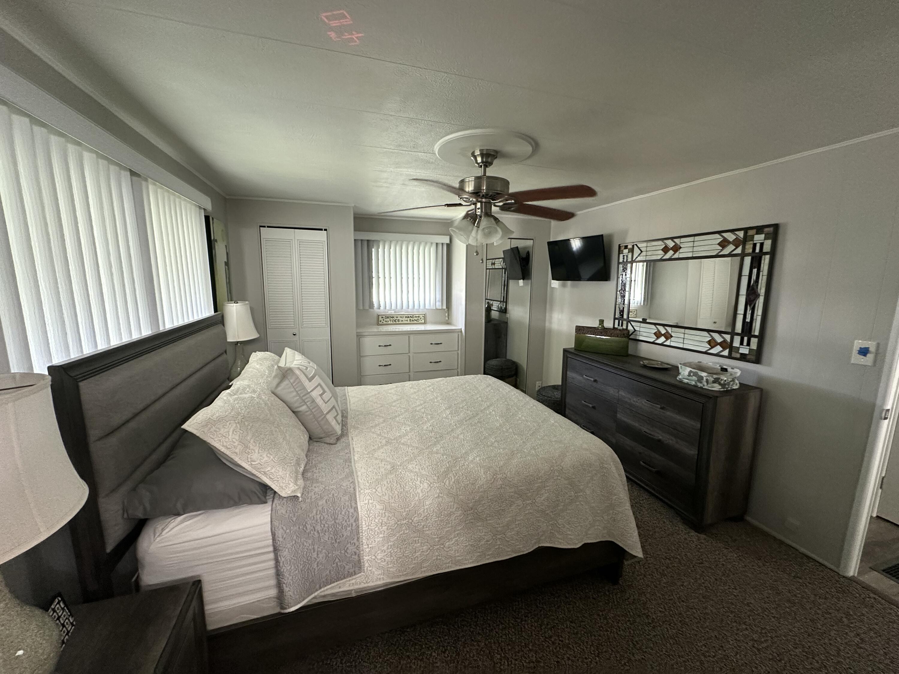 8281 South Street Boca Raton, FL 33433 - Photo 15 of 33 a bedroom with a bed wooden floor and window