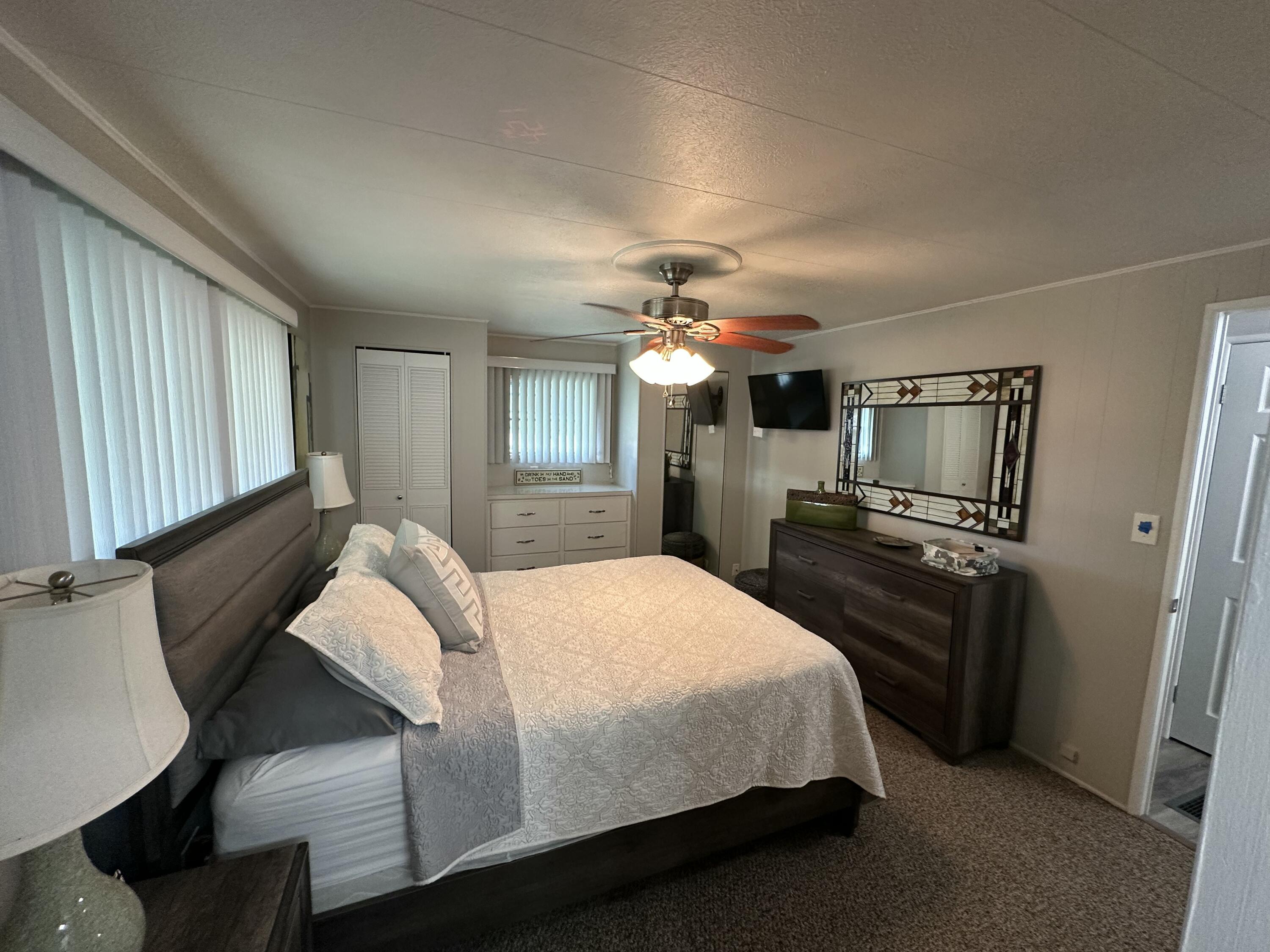 8281 South Street Boca Raton, FL 33433 - Photo 17 of 33 a bedroom with a bed and a flat screen tv