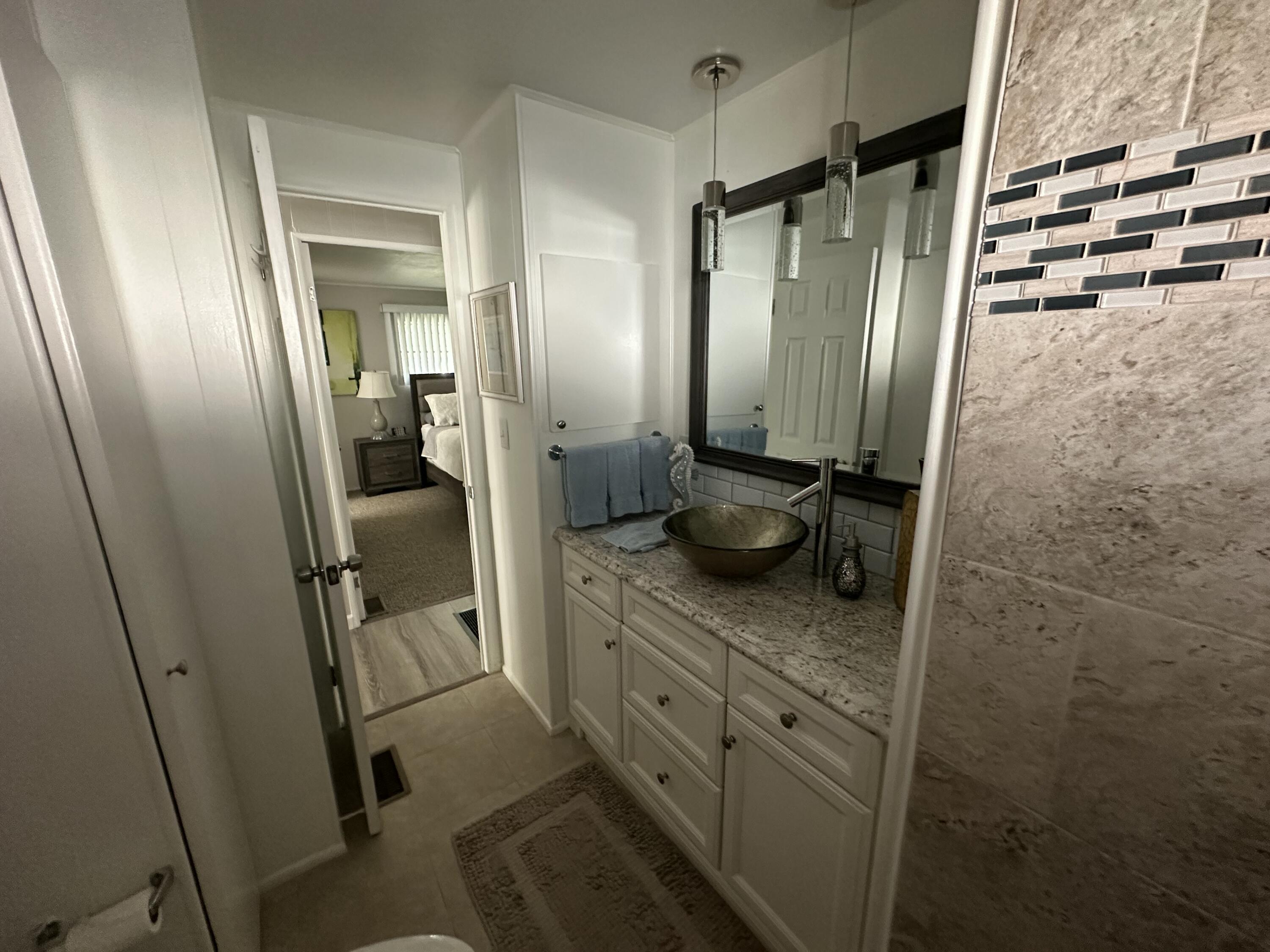 8281 South Street Boca Raton, FL 33433 - Photo 23 of 33 a bathroom with double vanity and a mirror