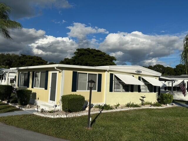 8281 South Street Boca Raton, FL 33433 - Photo 4 of 33 a view of house with yard and sitting area