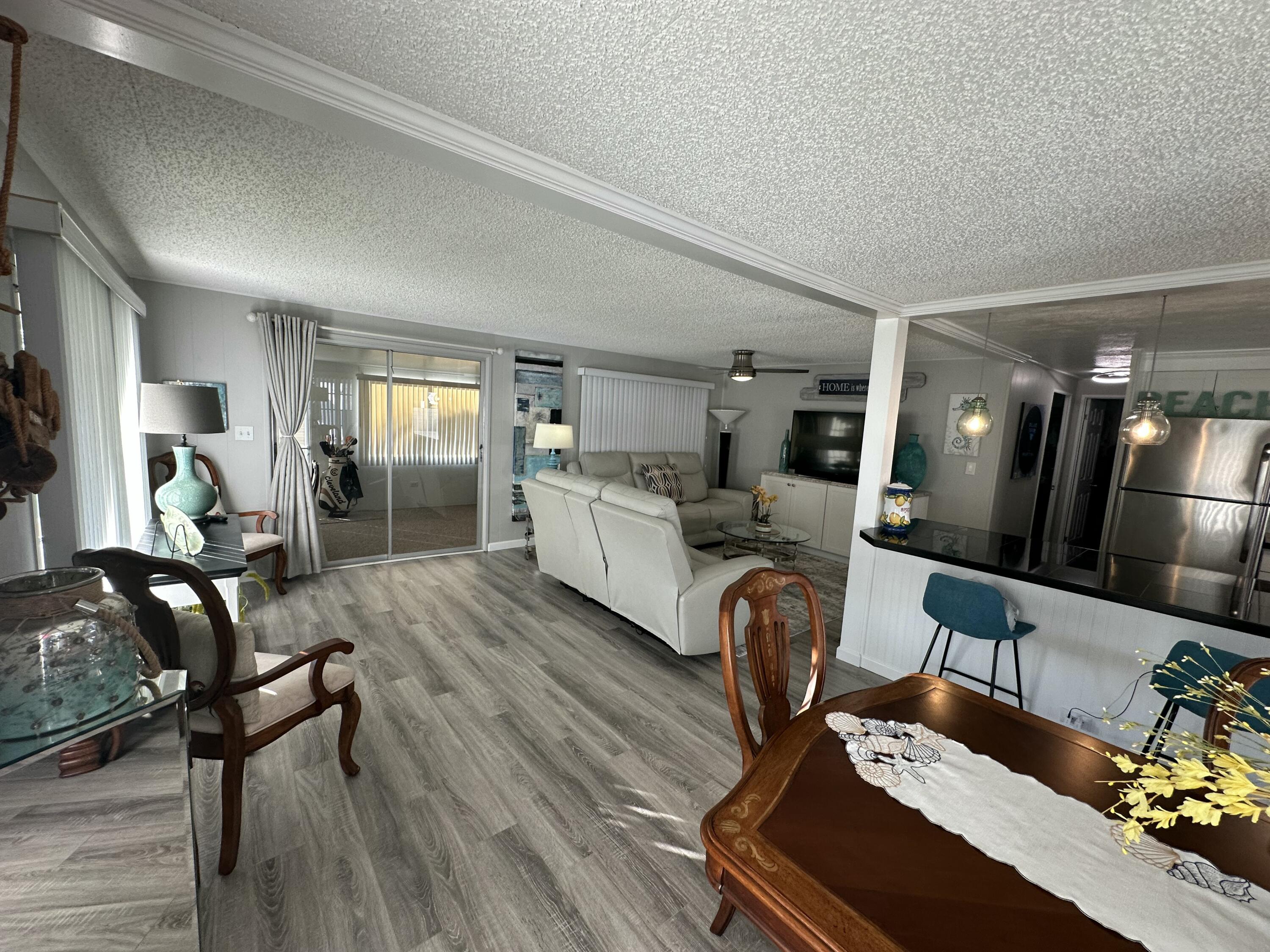 8281 South Street Boca Raton, FL 33433 - Photo 9 of 33 a living room with furniture and a chandelier