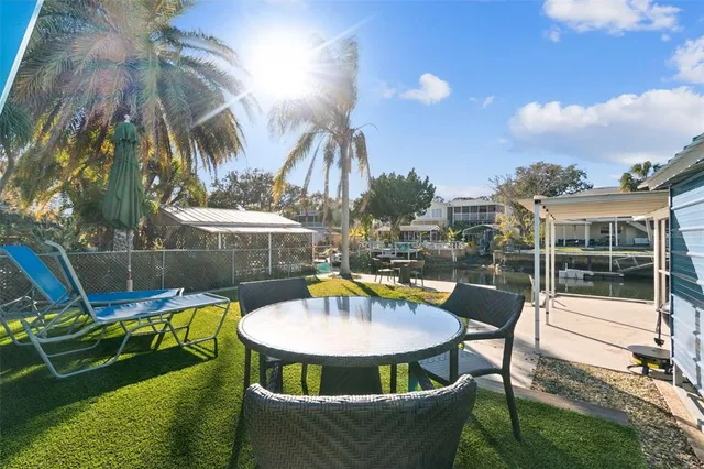 a view of a swimming pool with chairs and a table