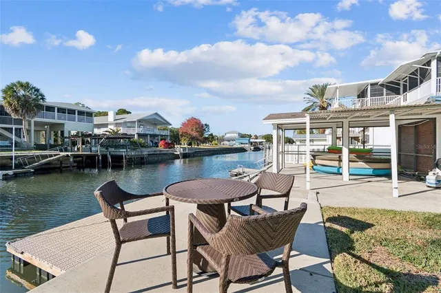 an aerial view of a swimming pool a yard and mountain view in back