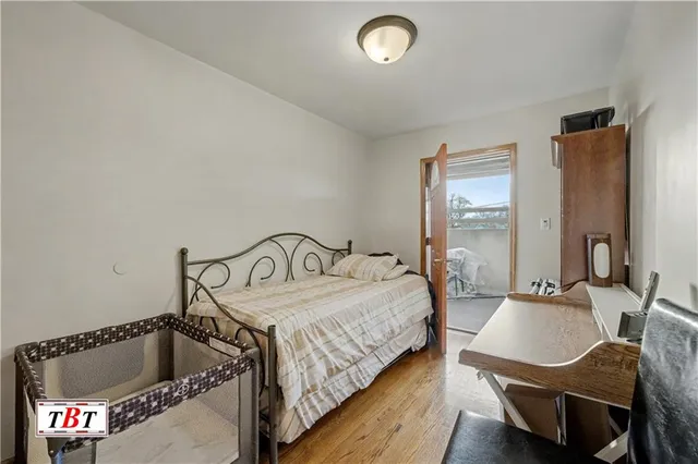 a bedroom with a bed and a potted plant