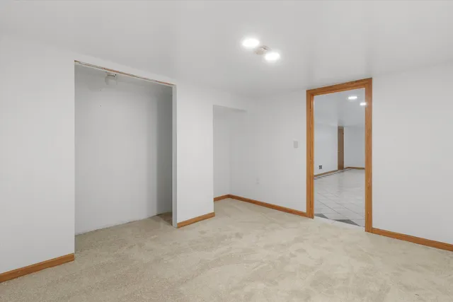 an empty room with closet and a bathroom