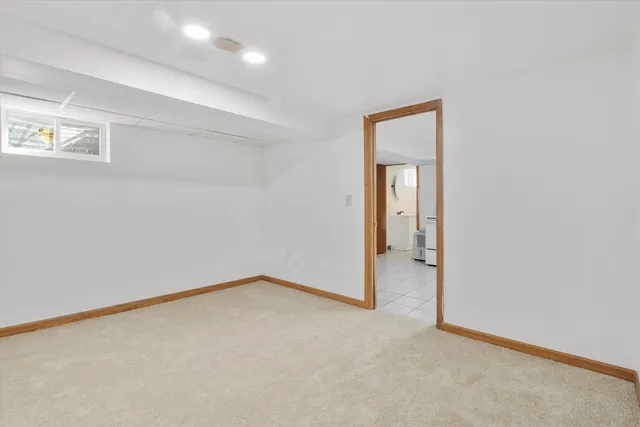 an empty room with a hallway and a window