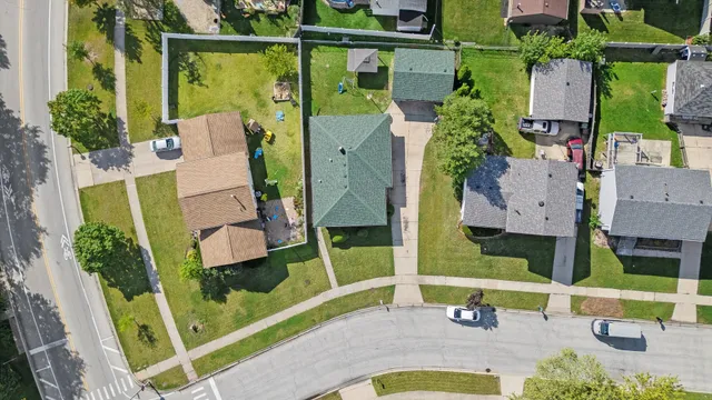 an aerial view of a house with a garden and swimming pool