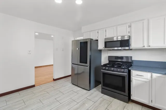 a kitchen with a stove and a refrigerator