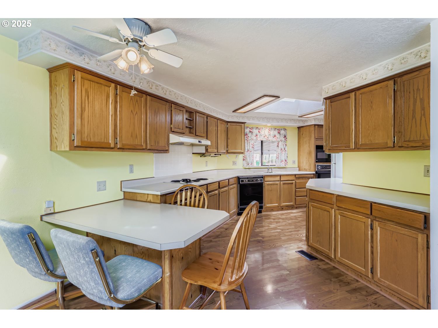 1504 Frontier Circle Forest Grove, OR 97116 - Photo 11 of 27 a kitchen with stainless steel appliances kitchen island granite countertop a table chairs in it and a microwave
