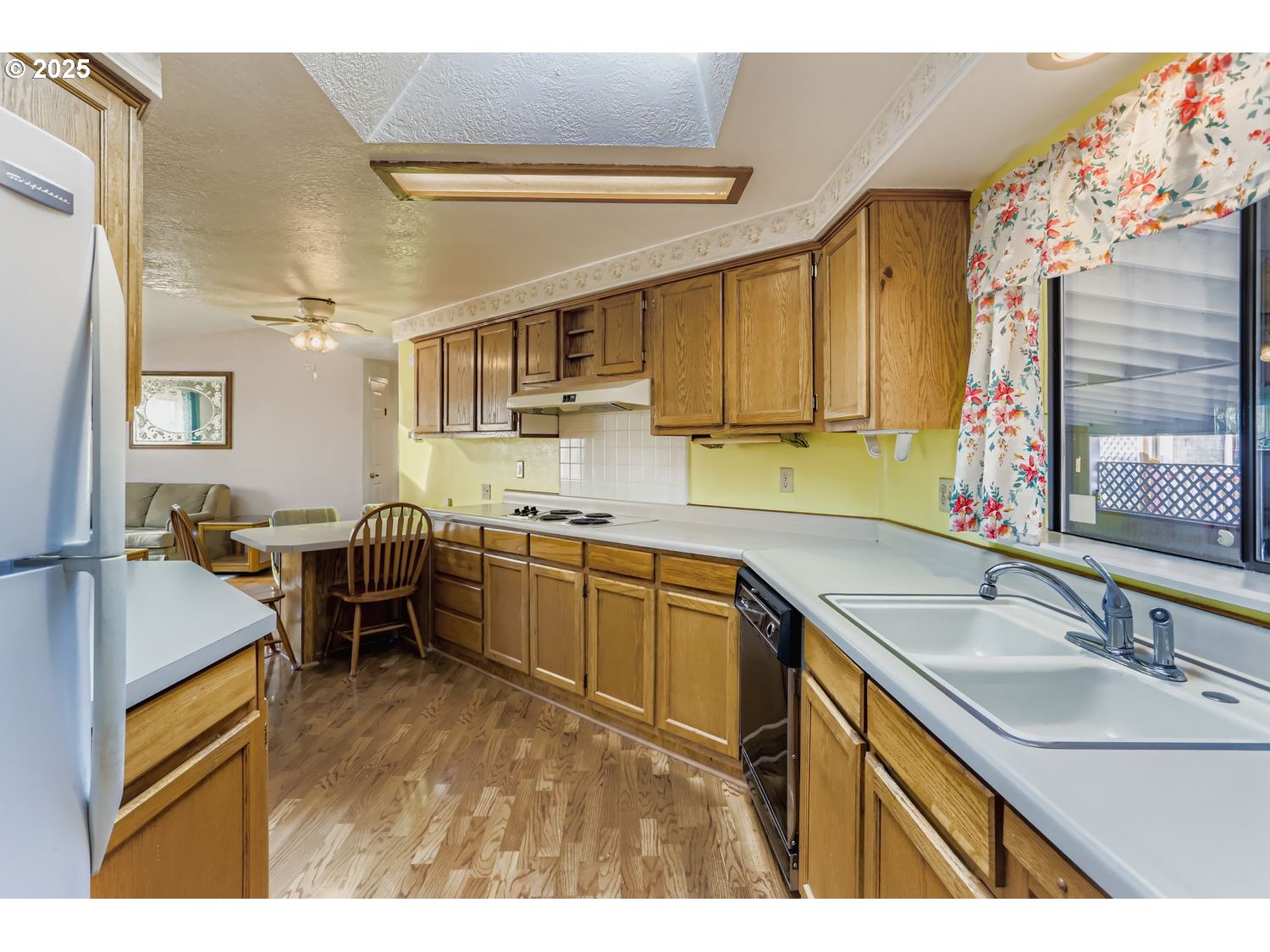 1504 Frontier Circle Forest Grove, OR 97116 - Photo 12 of 27 a kitchen with sink refrigerator and cabinets