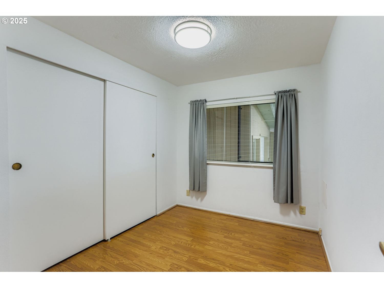 1504 Frontier Circle Forest Grove, OR 97116 - Photo 21 of 27 a view of an empty room with wooden floor