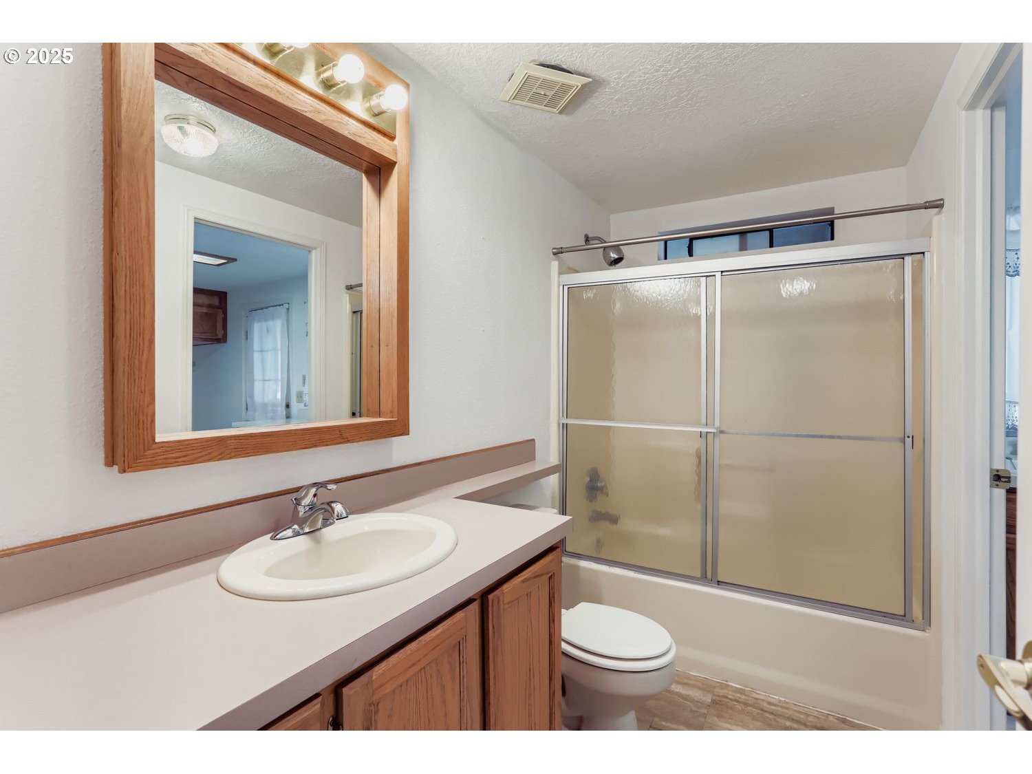 1504 Frontier Circle Forest Grove, OR 97116 - Photo 22 of 27 a bathroom with a sink a toilet a mirror and shower