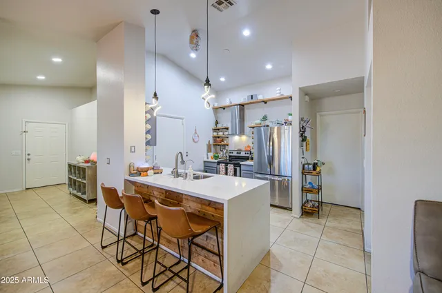 a large kitchen with a table and chairs