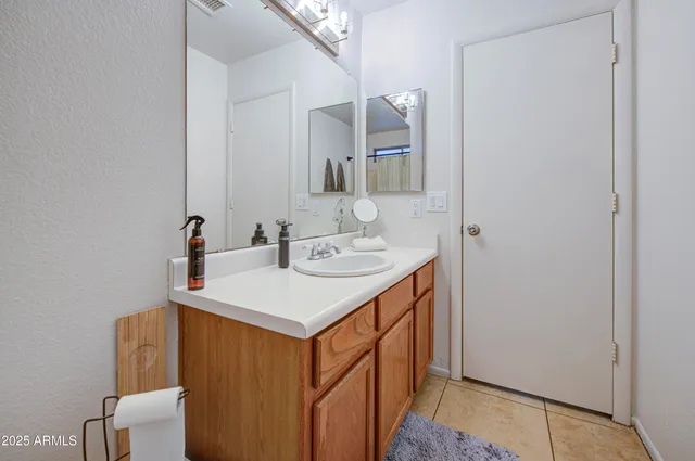 a bathroom with a sink a mirror and a toilet