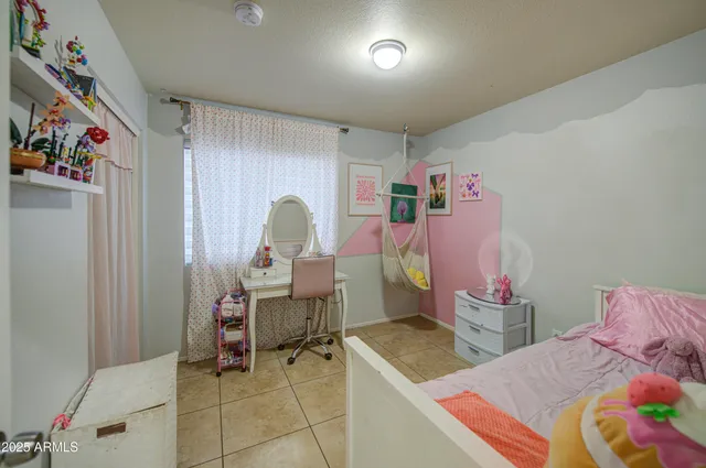 a bedroom with a bed and a desk