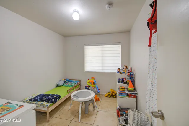 a room with furniture a rug and a window