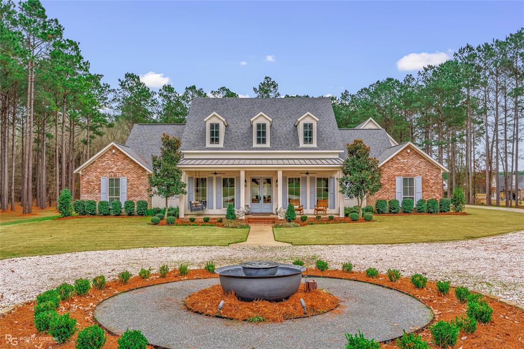 145 Crouch Road Benton, LA 71006 - Photo 1 of 40 a front view of a house with a yard and garage